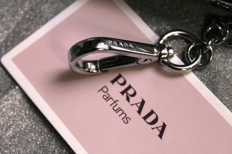 Amber by Prada perfume card and metal keychain