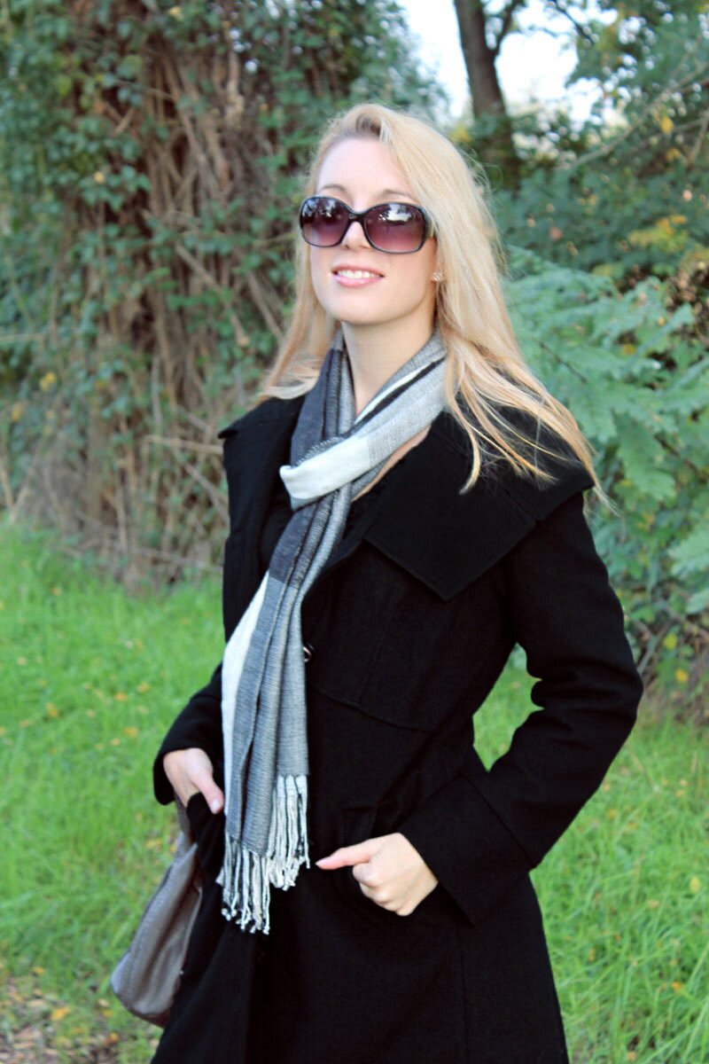 Fashion blogger Aurora Berill wearing a wrap scarf and tailored wool coat with oversized lapel collar