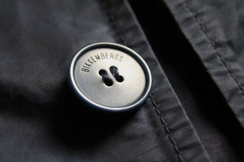 Close-up button detail on Bikkembergs women's single breasted trench coat