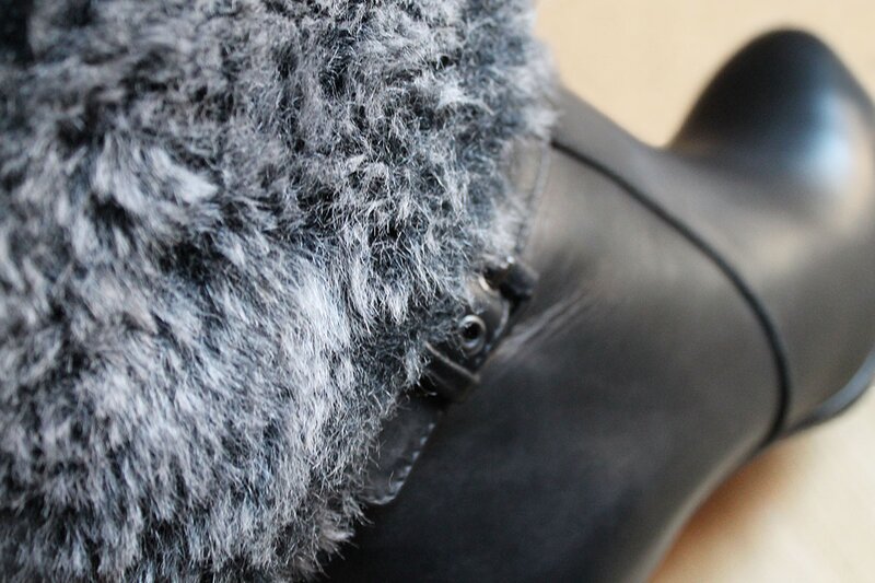 Side view of Bruno Premi black leather boots with a fur trim