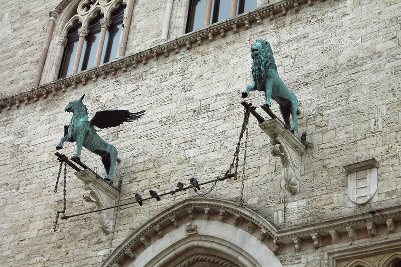 Perugia city center bronze sculptures adorning the entrace to Palazzo dei Priori, a medieval building with an art museum