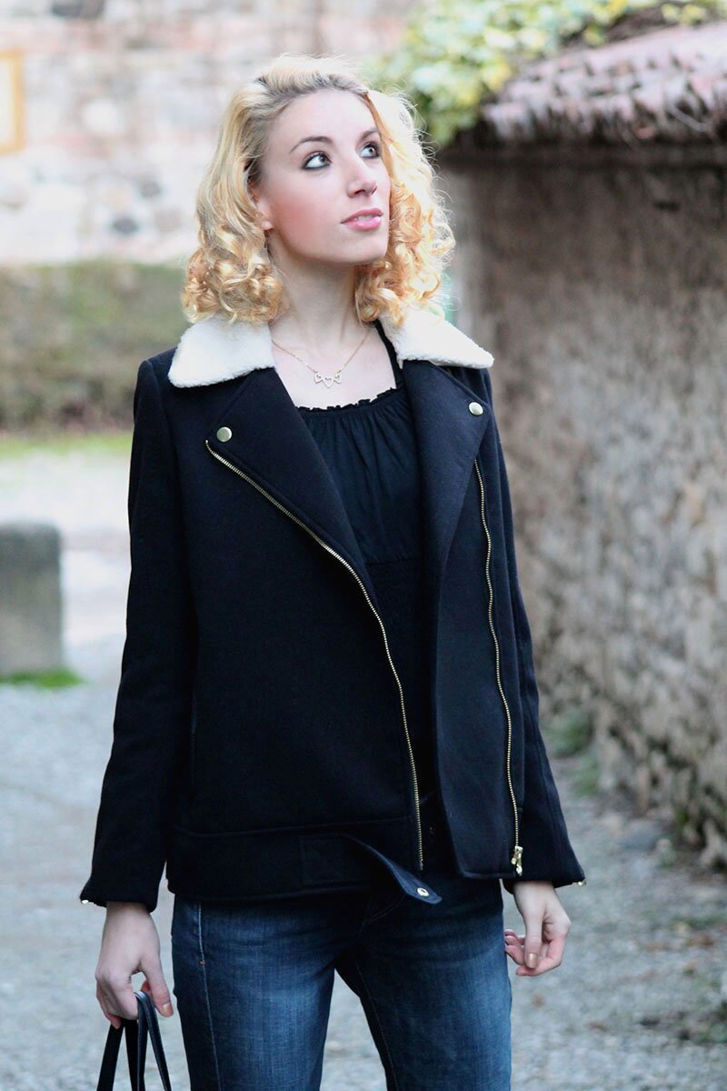 Fashion blogger Aurora Berill with curly hair wearing a H&M sherpa collar jacket