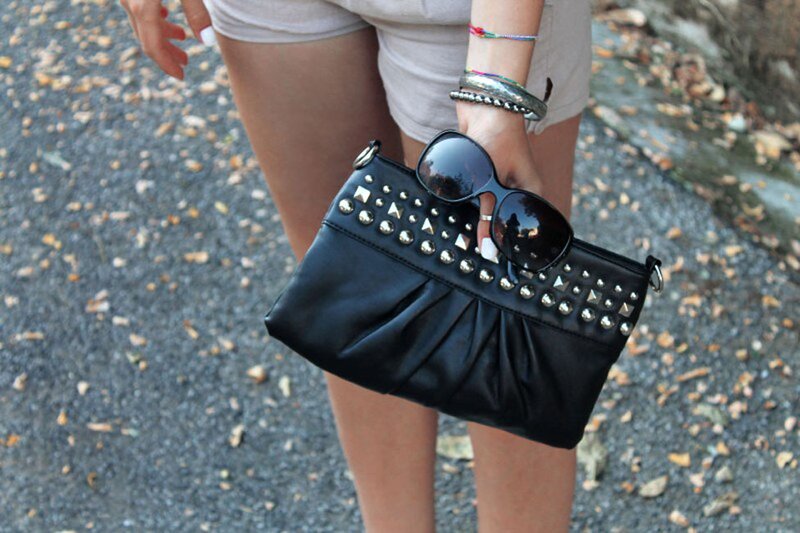 Fashion blogger Aurora Berill wearing a studded leather bag, H&M sunglasses and silver jewelry